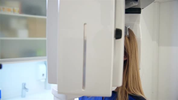 Woman Patient Standing In Dental Computed Tomograph.