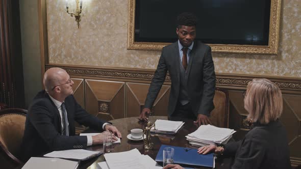 African American Lawyer Shaking Hands with Business Partners on Meeting alt