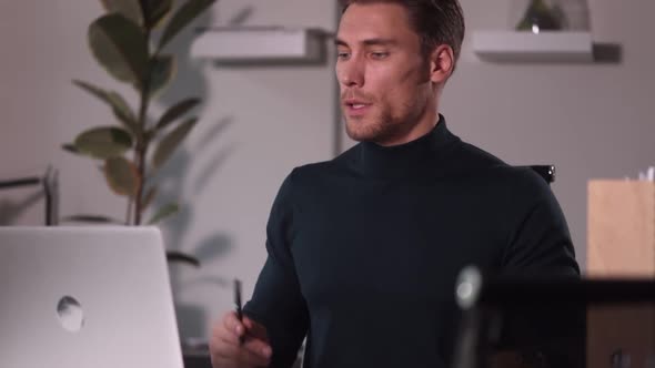 Man Wires Meeting Over Computer and Draws Attention to Screen with Spbi Pen alt