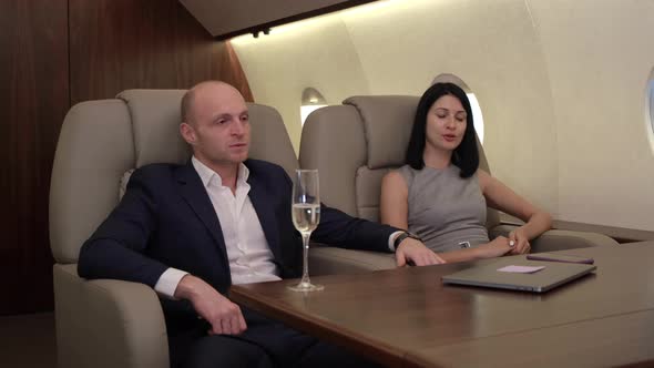 Close-Up Of A Young Couple Man Woman Serious Tired Working At The Computer Discussing alt