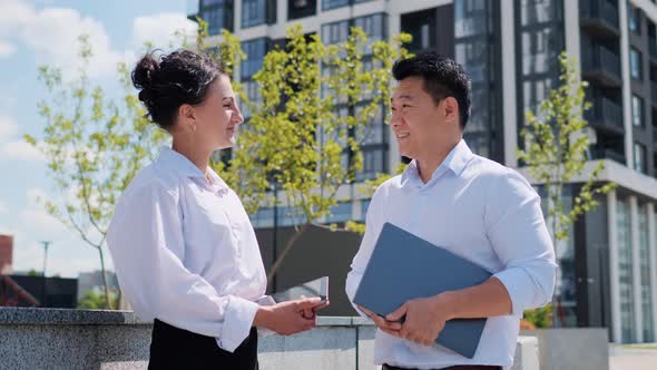 Asian Businessman Manager and Female Businesswoman Standing Outdoor Talking alt