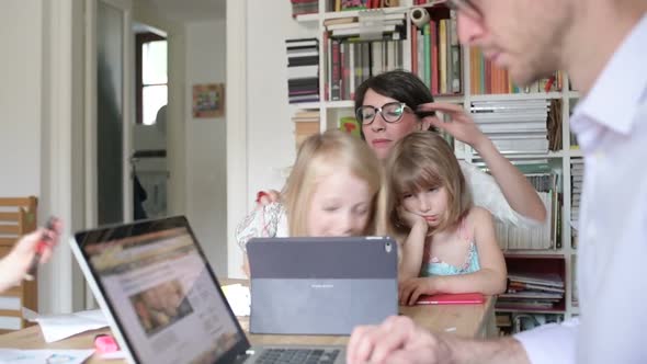 family with three children indoor using tablet - togetherness, technology, entertainment concept alt