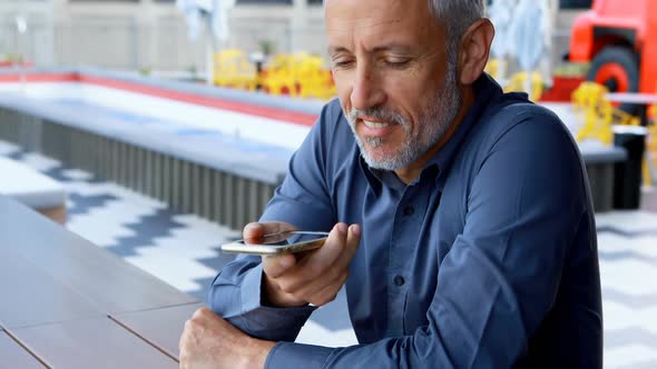 Businessman talking on mobile phone in hotel 4k alt