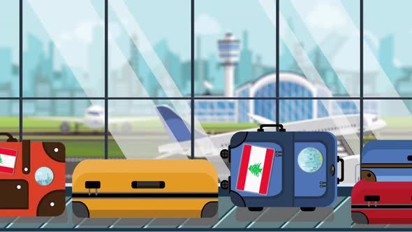 Suitcases with Lebanese Flag Stickers on Baggage in Airport alt