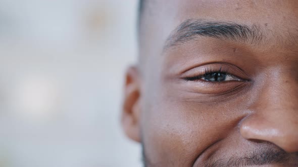 Closeup One Black Male Eye Looks at Camera with Happy Gaze alt