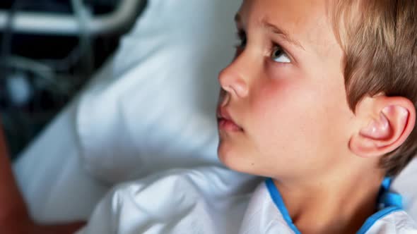 Female doctor examining patient ear with otoscope alt