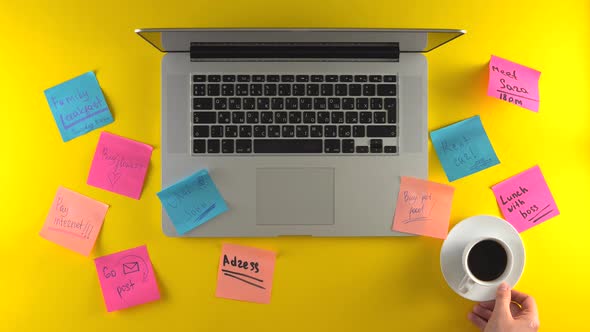 Workplace with Post It Papers on Desk Laptop on Yellow Background Coffee Break