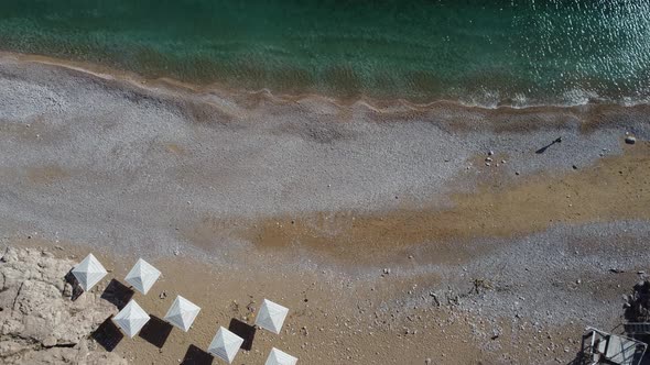 Aerial View From Above on Azure Sea and Pink Pebbles Beach alt