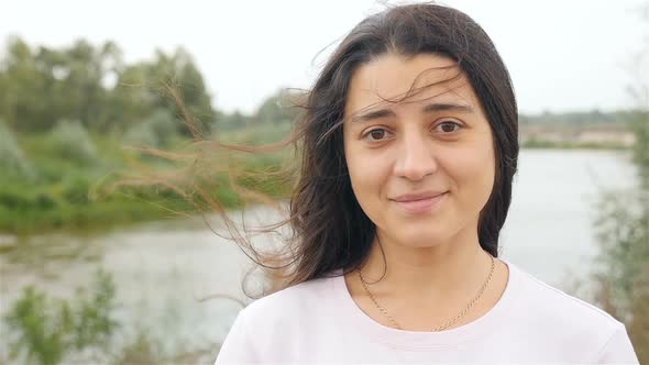 Beautiful Girl Looking at the Camera and Smiling alt