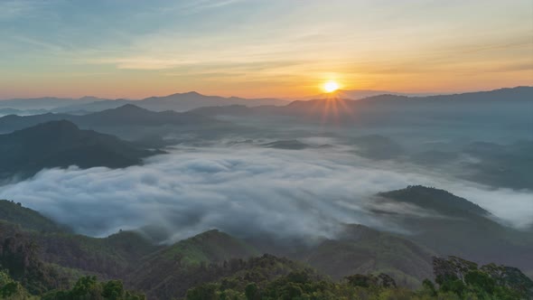 4K Timelapse of beautiful sunrise with fog rolling over mountain, Yala, Thailand alt