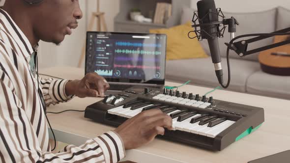 African-American Man Creating Music at Home alt