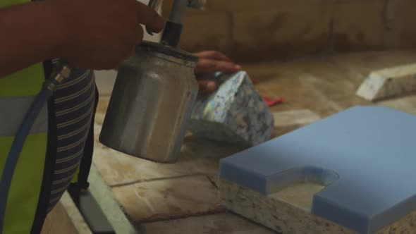 Worker washing a piece of concrete block alt