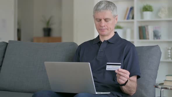 Middle Aged Businessman Making Successful Online Payment on Laptop  alt