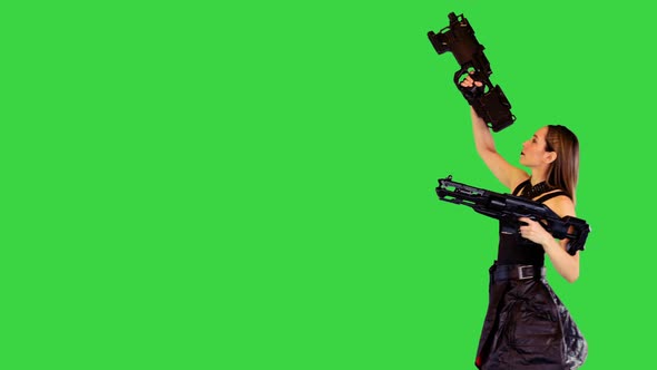 Shootercharacter Girl Passes with Guns in Hands Raising One on a Green Screen Chroma Key
