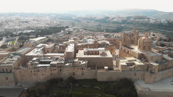 Mdina, view outside city walls overlooking the cityscape limestone buildings in Malta alt