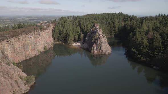Picturesque View Of Carrigfoyle Quarry Lake With Crag And Coniferous Forest In Barntown, County Wexf alt