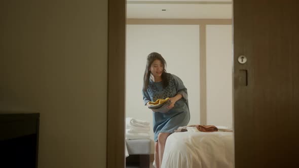 happiness travel asian female woman arrange cloth and stuff after checkin at hotel