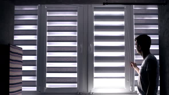 Man checking cassette roller blinds on windows. alt