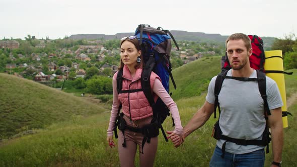 Happy Couple Man and Woman in the Mountains Travel in Search of a Vacation Spot alt