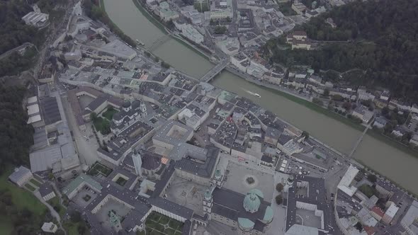 Aerial view of Salzburg cityscape boat floating on river Salzach architecture cathedral. Austria