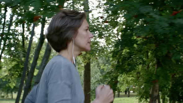 Beautiful Woman Running with Headphones alt