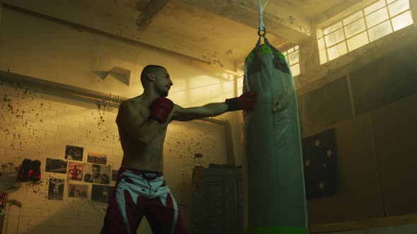 Man punching the boxing bag alt
