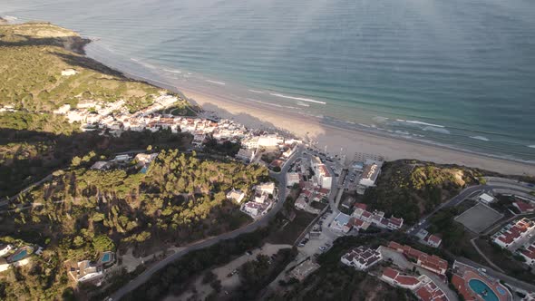 Picturesque seaside Salema village, Algarve. Paradisiac sand beach and emerald sea. alt