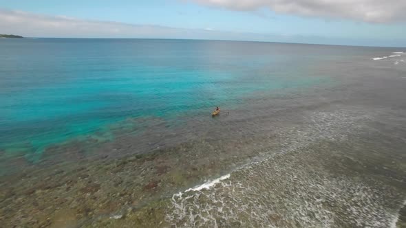 Cinematic Pull Back Aerial From Traditional Fishing Boat Revealing Majestic Colorful Beach of Tropic alt