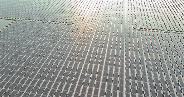 Aerial View of Platform System of Floating Solar Panels in Blue Pond the Sunlight alt