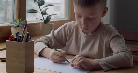 Front Side View of Preschool Child Drawing Picture at Home Slow Motion