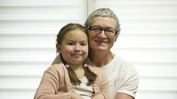 Portrait of a Grandmother and Granddaughter 67 Years Old