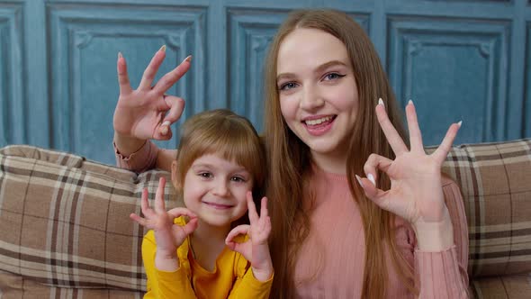 Portrait of Little Child Kid Daughter with Young Mother Hugging Embracing Showing Ok Gesture Sign alt