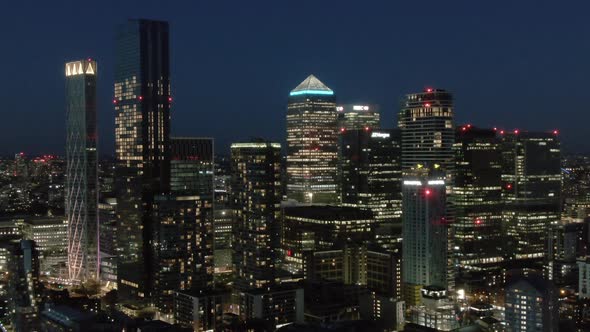 Downtown skyscrapers illuminated at night, London, UK