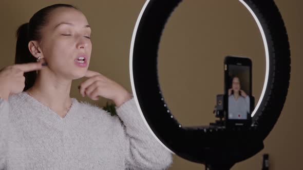 Young Blogger Doing Skin Fitness Exercises for Face Contour, Broadcasting