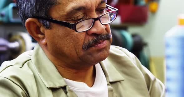 Cobbler working in workshop alt