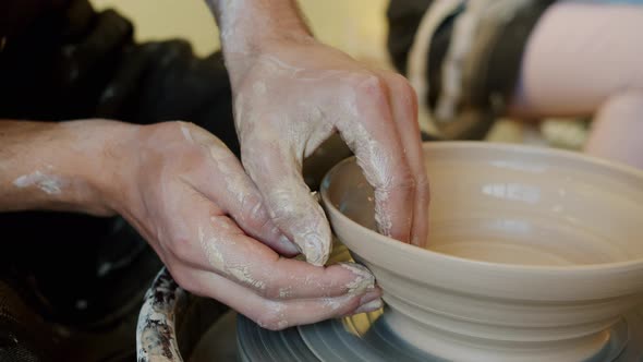 Close-up of Guy's Hands Making Bowl with Clay on Pottery Wheel in Workshop alt