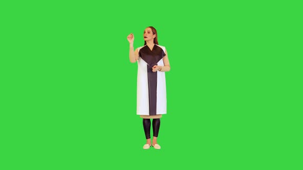 Robotic Girl Stands Pushing Virtual Buttons on a Green Screen Chroma Key