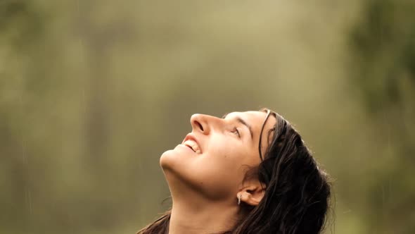 Close-up of the Face of a Young Happy Woman Enjoying the Warm Summer Rain.