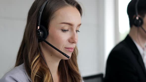 young beautiful women call center wear headset and working with computer while consulting customer alt