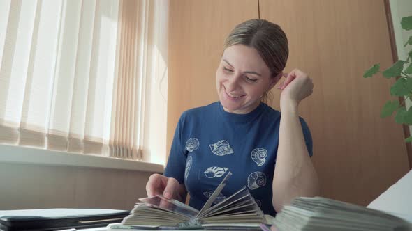 Woman Recalls Funny and Pleasant Moments of Her Life with Help of Photo Album