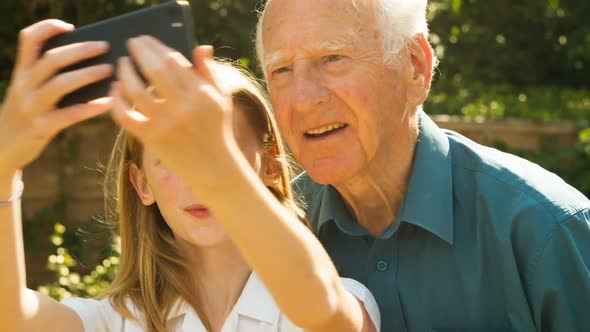 Elderly man and his Grand Daughter taking selfies