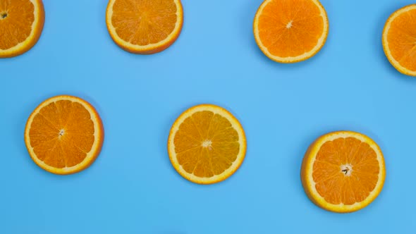 Rotating Background with Slides of Orange on a Blue Background Trendy Summer Fruity Background