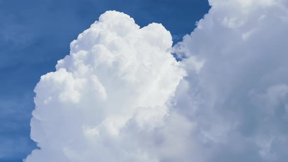 Timelapse of White Puffy Cumulus Clouds Forming on Summer Blue Sky alt