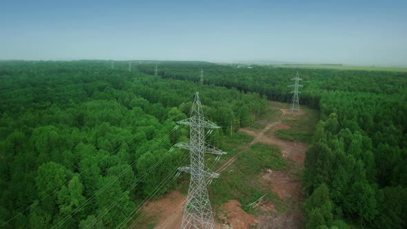 Electric High Voltage Alternative Energy Power Transmission Line Tower Extending Into the Forest