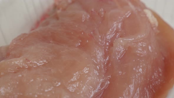 Slow pan over  frozen food close-up 4K 2160p 30fps UltraHD video - Chicken breasts packed in a box 3 alt