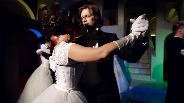 Cute Couples of Classical Ballet Dancers Performing Waltz Moves in a Castle Under Neon Light alt