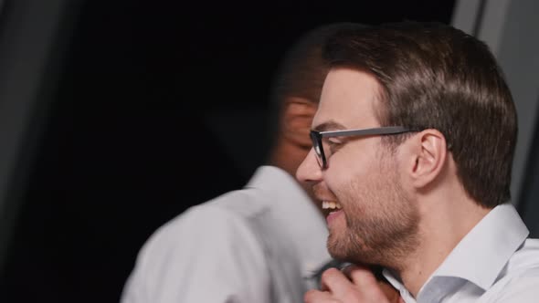 Smiling young business people celebrating successful business deal alt