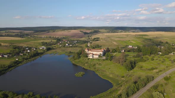 Aerial Drone Shot of Historic Castle on Hill Near Lake Medieval Architecture and Cultural Landmark alt