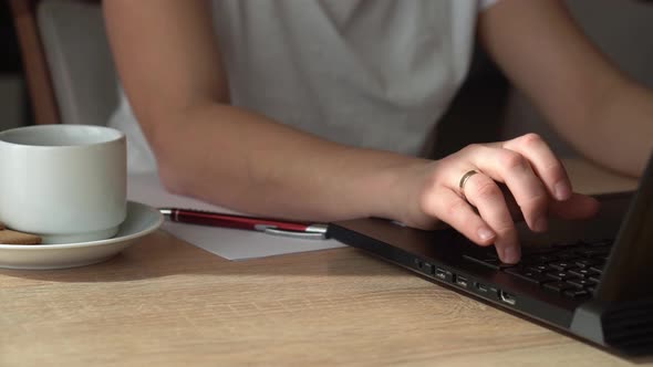 Close Up Hands Of Young Woman Chatting On Laptop At Home In Living Room alt