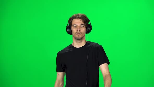 Brunette Guy in Big Headphones Is Running, Chroma Key. Slow Motion alt